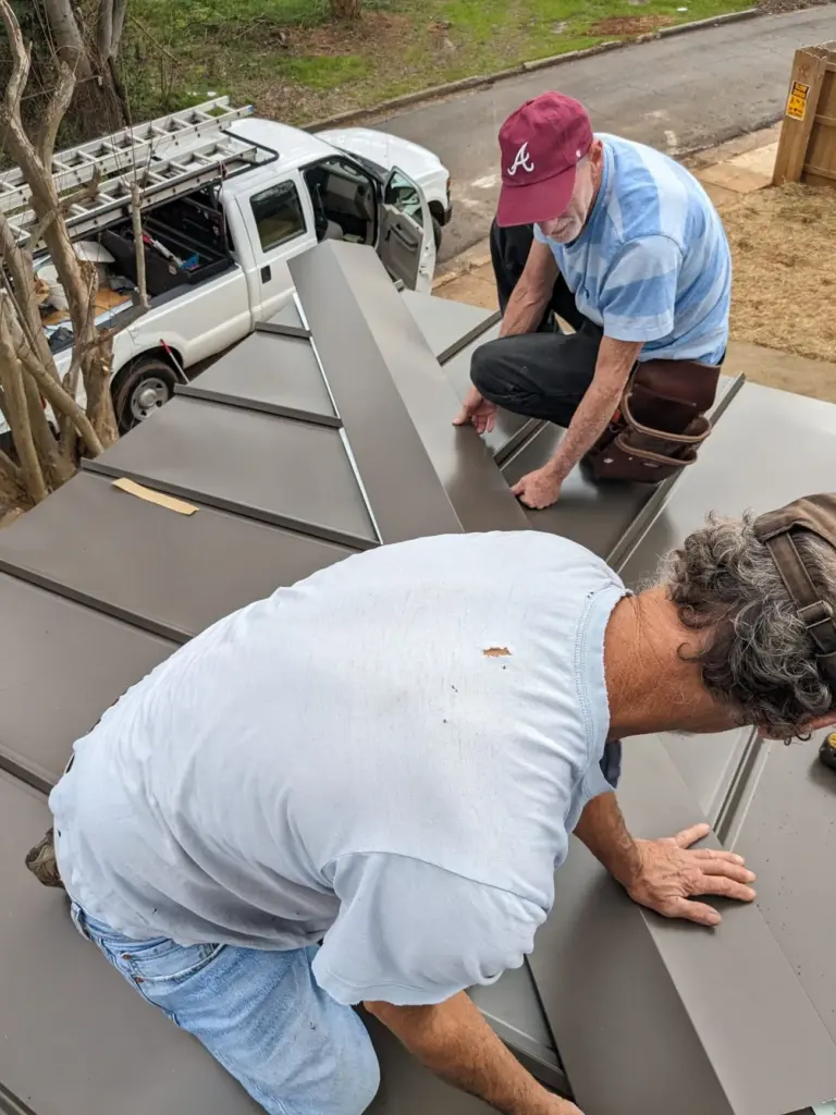 Roofing crew installing a standing seam metal roof in Columbus, GA