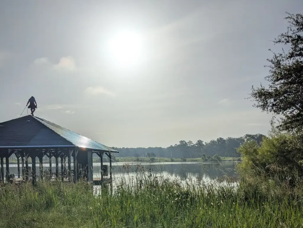 New metal roof being installed on a lakeside boathouse